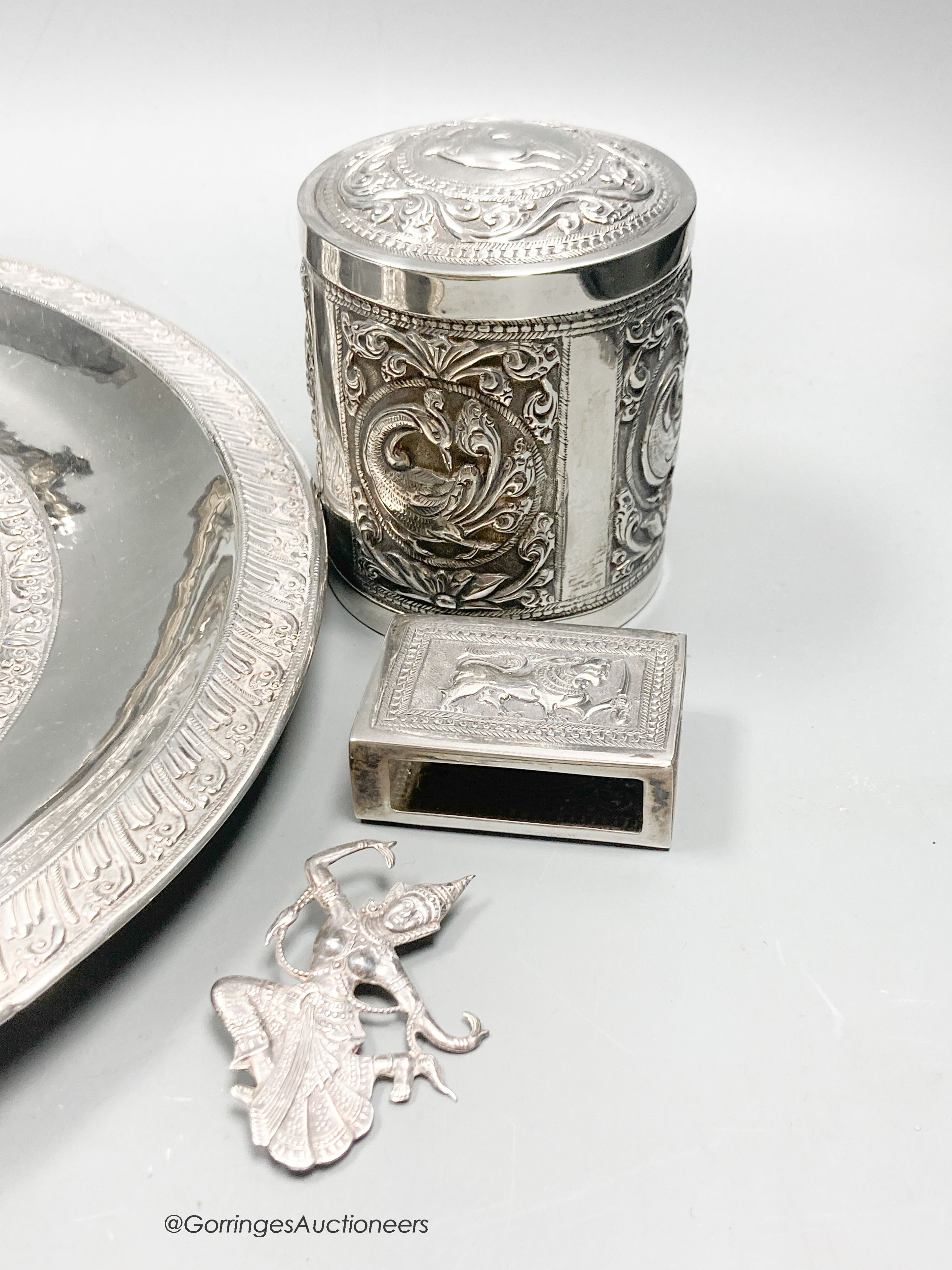 A Malaysian white metal mounted horn, a Thai cylindrical container and cover, other Thai and Eastern white metal items.